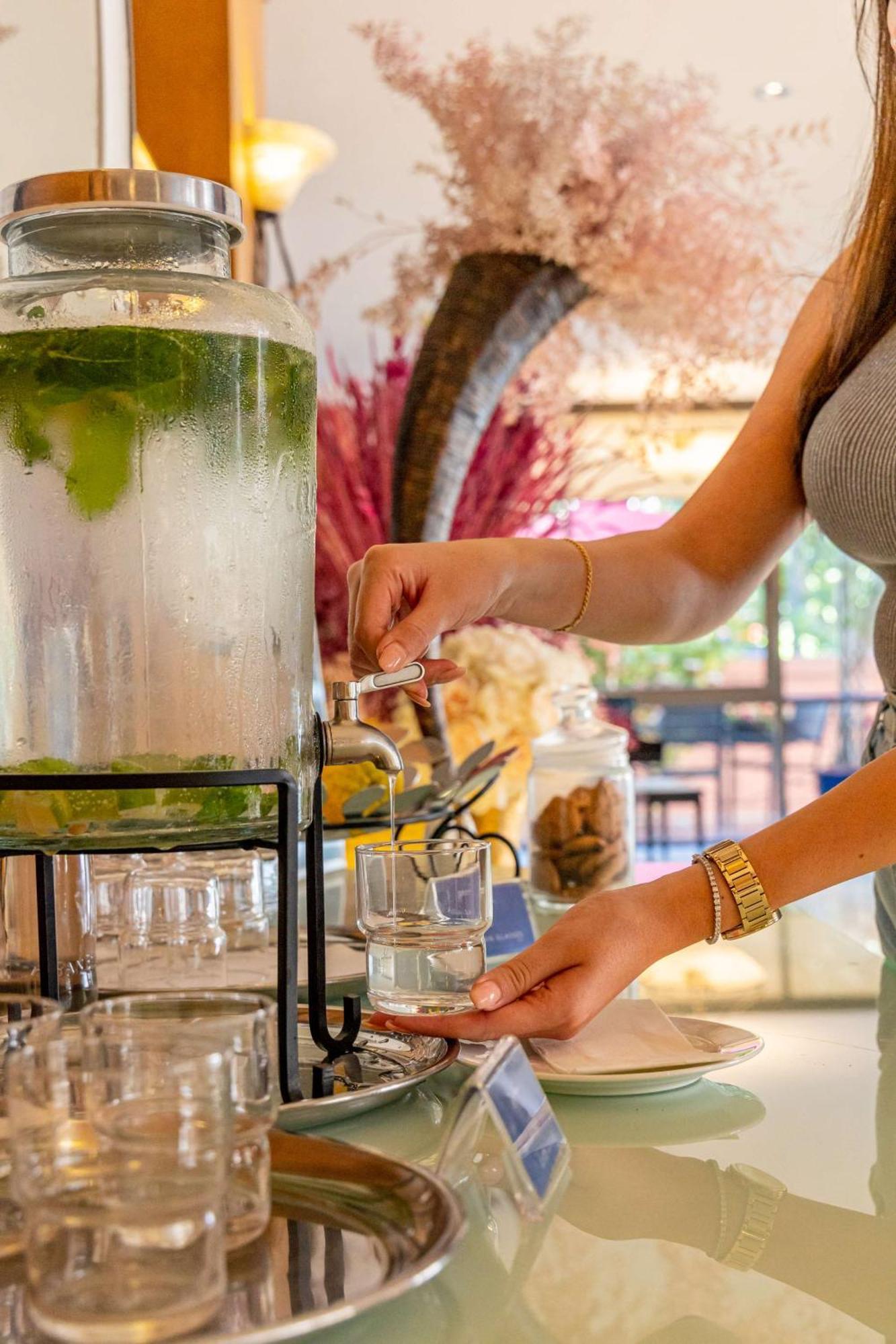 Radisson Blu Martinez Beirut Hotel Kültér fotó A woman filling a glass with a beverage